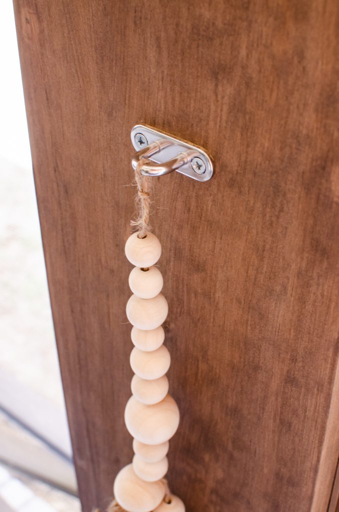 Metal ring with wooded beaded tassel tie back for curtains | HauteHouseLove.com