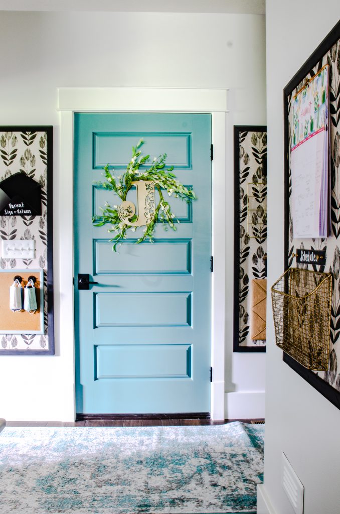 Garage Entry with colorful door and organized command center