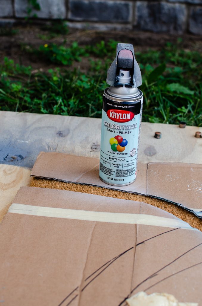 Can of Spray Paint and Cardboard for DIY Doormat Template