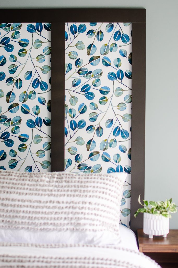 Blue eucalyptus wallpaper faux headboard in a master bedroom