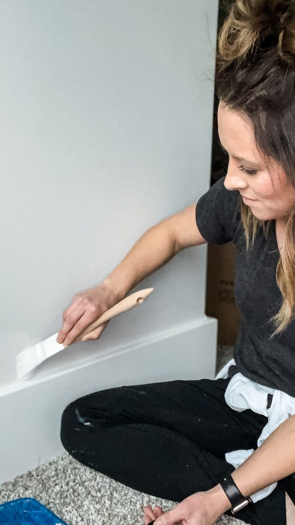 woman cutting in a Wall with paint