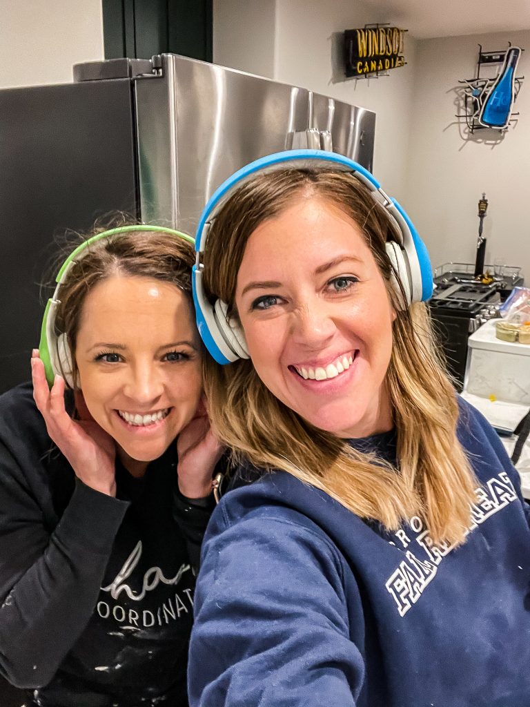 Emily and Kera Jeffers wearing kids headphones because the tile saw is loud | HauteHouseLove.com