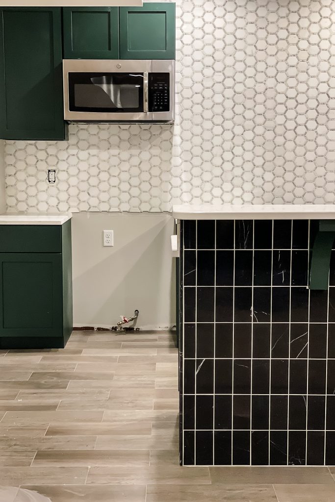 Basement Bar Designed with black and white tile by Jeffrey Court.