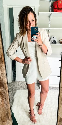 mirror selfie of womanin a white romper, blush strappy heels, and cream blazer | HauteHouseLove.com