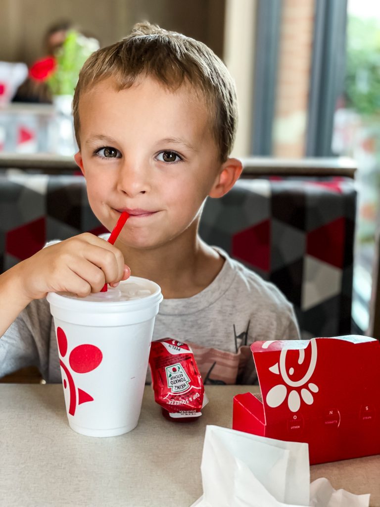 little boy enjoying Chick-fil-a meal