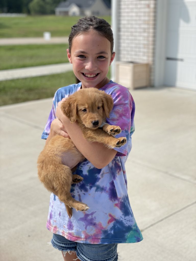 girl holding puppy