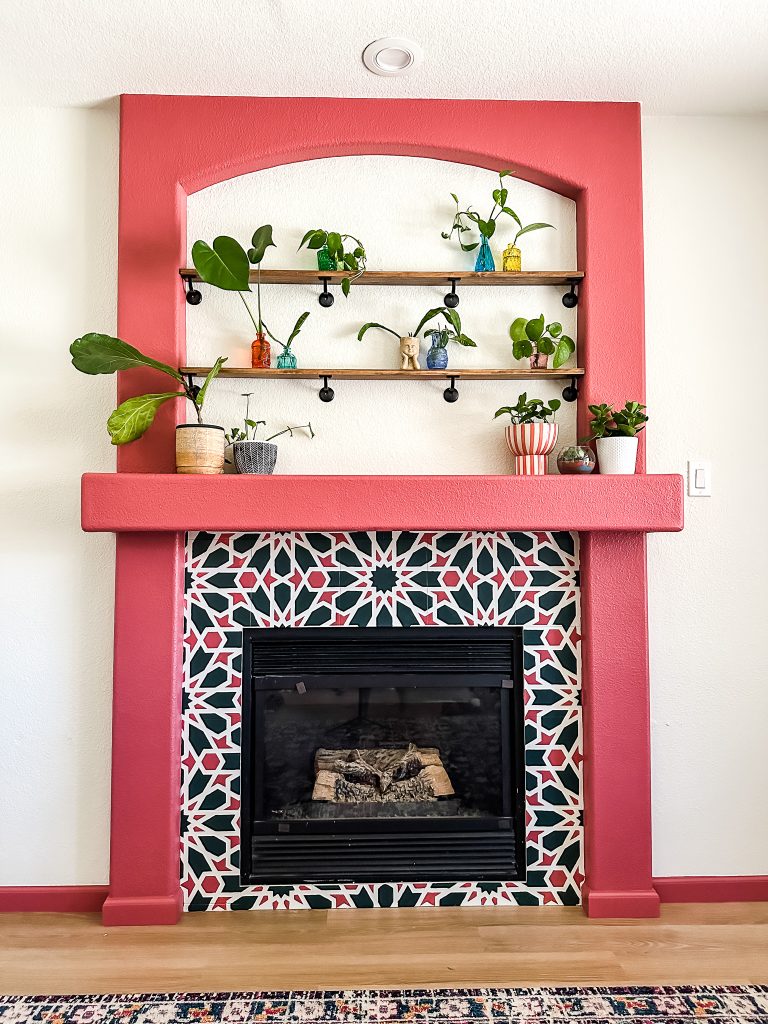 DIY Plant Shelves over a painted tile fireplace.