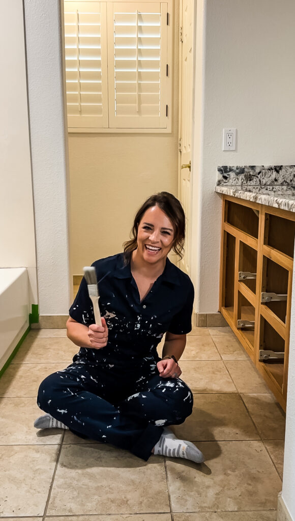 woman with paint brush about to paint her bathroom tile floors